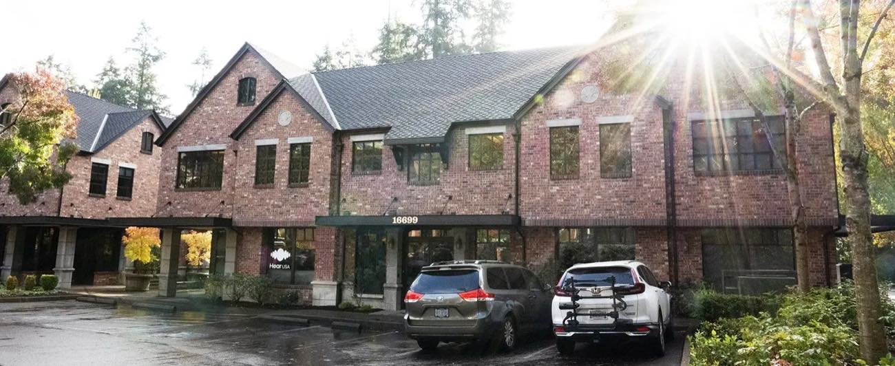 The brick office building at 16699 Boones Ferry Road, with parking in front of the entrance
